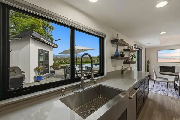 a kitchen with a large window and a sink