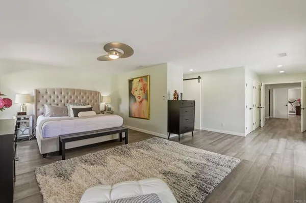 a bedroom with a bed and a dresser