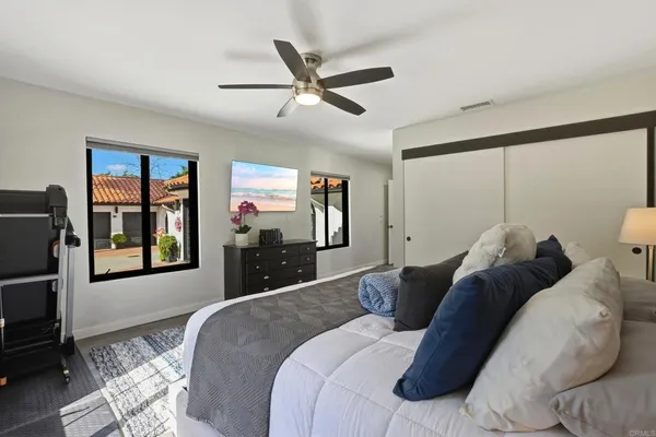 a bed sitting in a bedroom next to a window