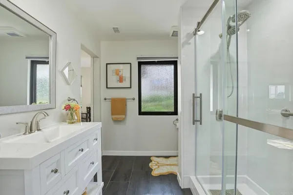 a bathroom with a sink mirror and vanity