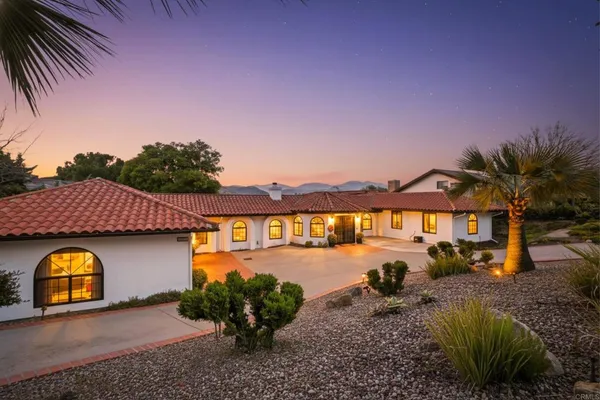 a view of a house with pool yard and a patio
