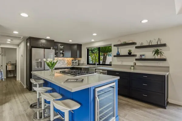 a kitchen with a stove a sink and a refrigerator