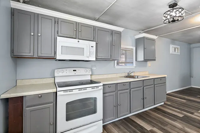 a kitchen with a sink stove and cabinets