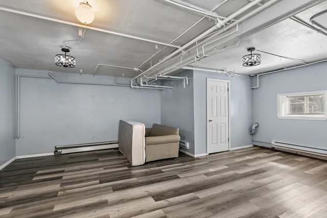 a view of a room with wooden floor