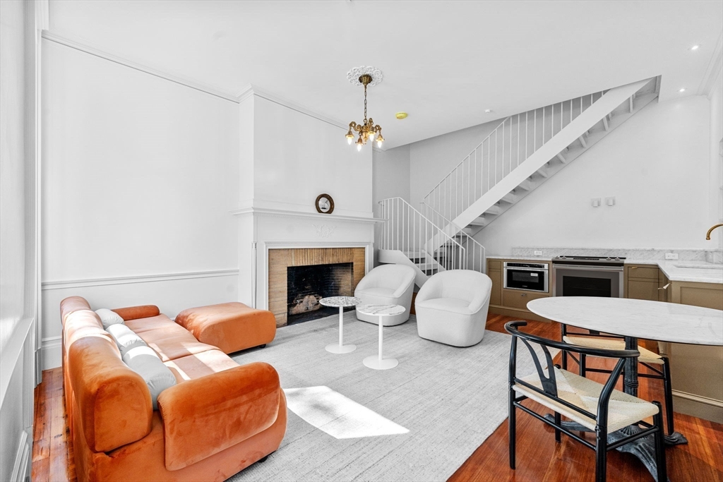 320 Tappan Street, Unit 1 Brookline, MA 02445 - Photo 1 of 10 a living room with furniture and a fireplace