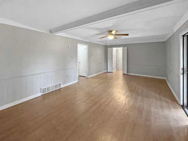 wooden floor in an empty room with a window