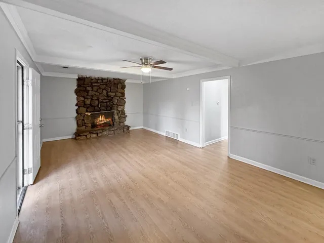 wooden floor in an empty room with a window