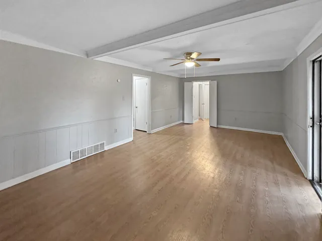 wooden floor in an empty room with a window