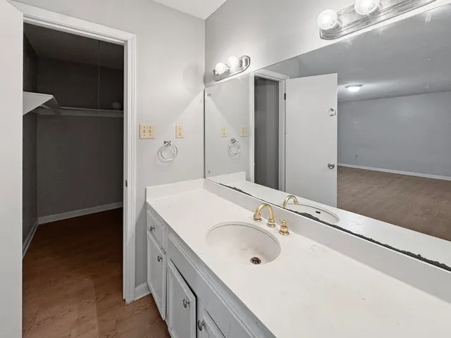 a bathroom with a double vanity sink and mirror