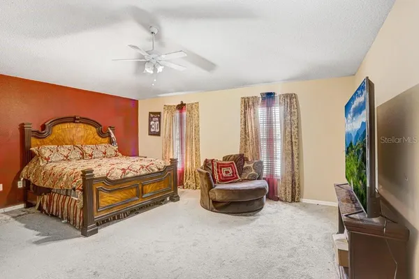 a bedroom with a bed and a flat screen television