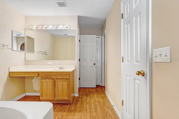 a bathroom with a sink a mirror and a shower