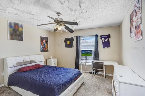 a bedroom with a bed and a chair