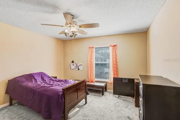 a bed room with a bed and a window