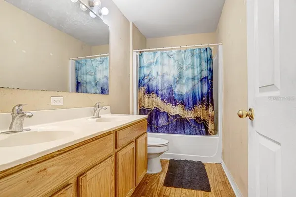 a bathroom with a sink a mirror and a shower