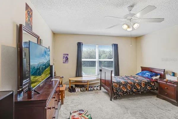 a bedroom with furniture and a flat screen tv