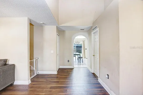 a view of a hallway with wooden floor
