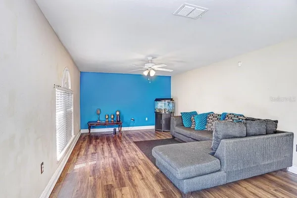 a living room with furniture and a chandelier