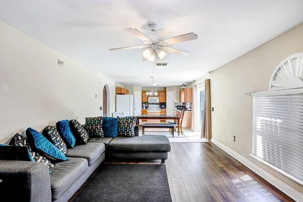 a living room with furniture and wooden floor