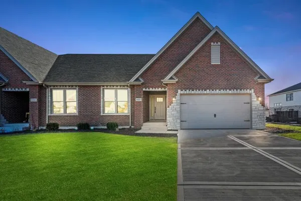 a front view of a house with a yard and garage