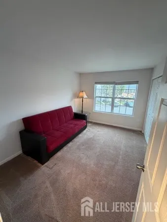 a living room with a couch and a window