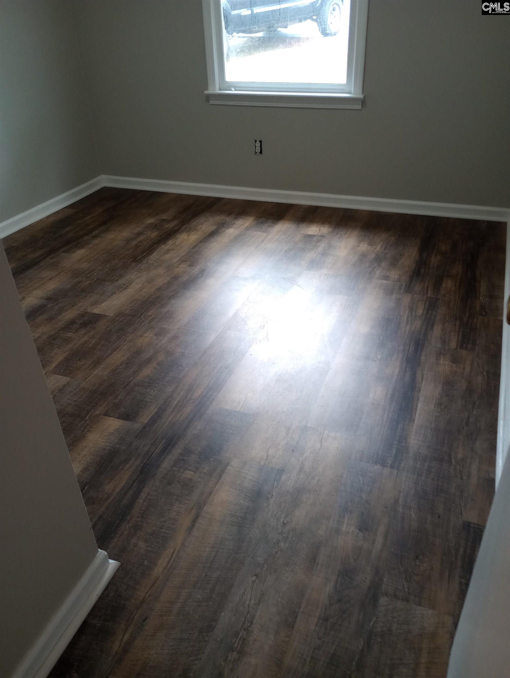 2444 Watson Street, Unit B Elgin, SC 29045 - Photo 4 of 5 an empty room with wooden floor and windows