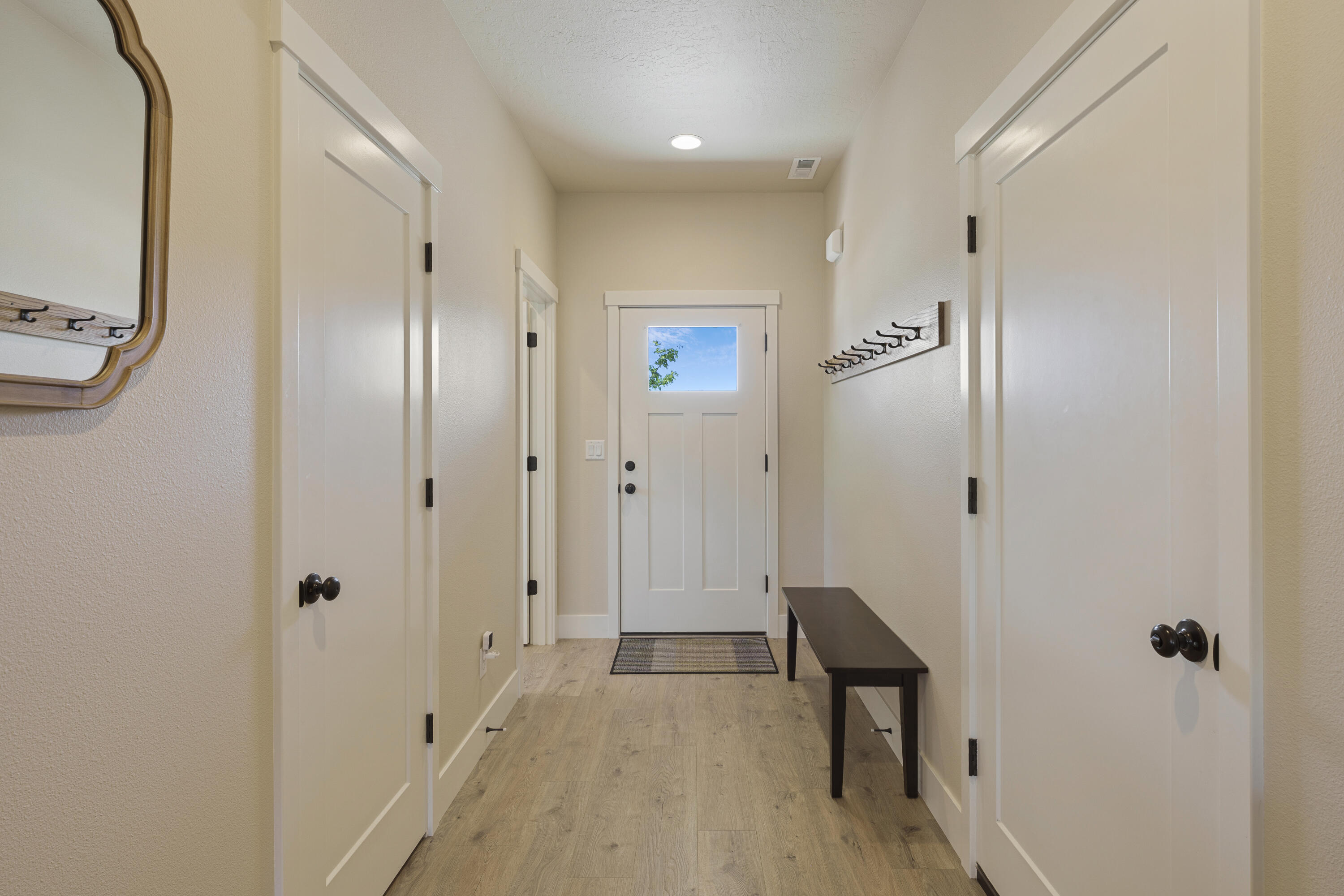 4999 Southwest Yew Place Redmond, OR 97756 - Photo 7 of 50 a view of a hallway with wooden floor and staircase