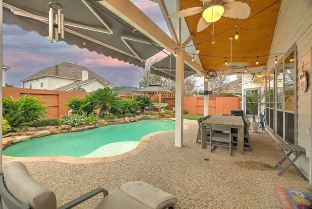 a view of a patio with a table and chairs
