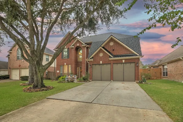 a front view of a building with a yard