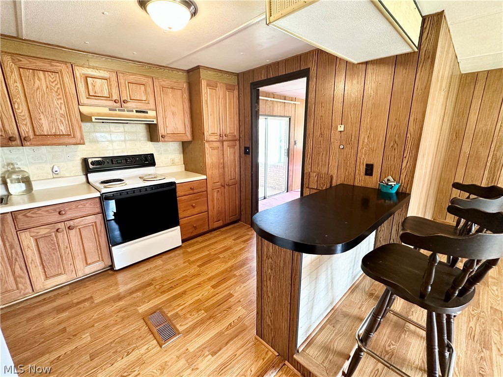 28 Richter Road Colliers, WV 26035 - Photo 5 of 38 Eat-in kitchen featuring hardwood floors and appliances