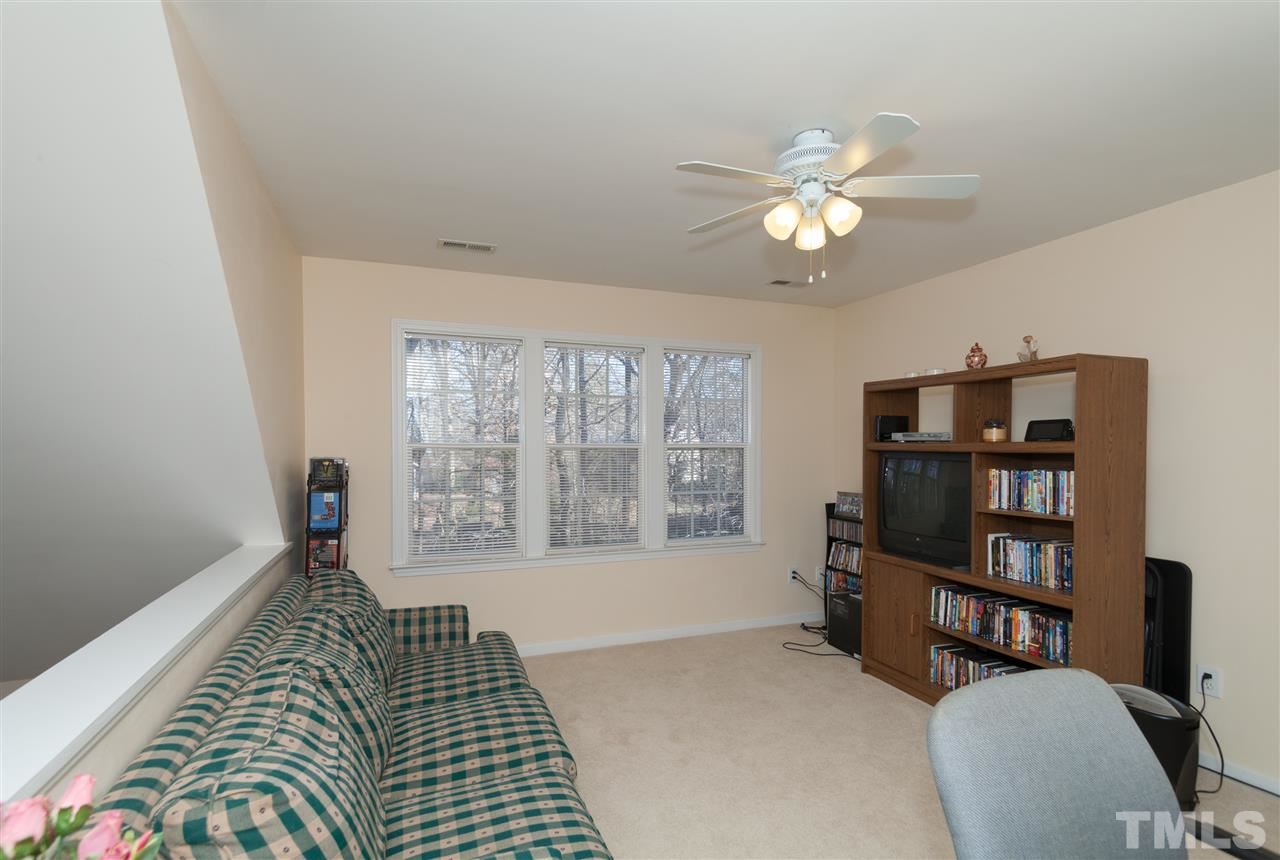 5602 Slide Rock Lane Raleigh, NC 27613 - Photo 11 of 19 a bedroom with furniture and a book shelf