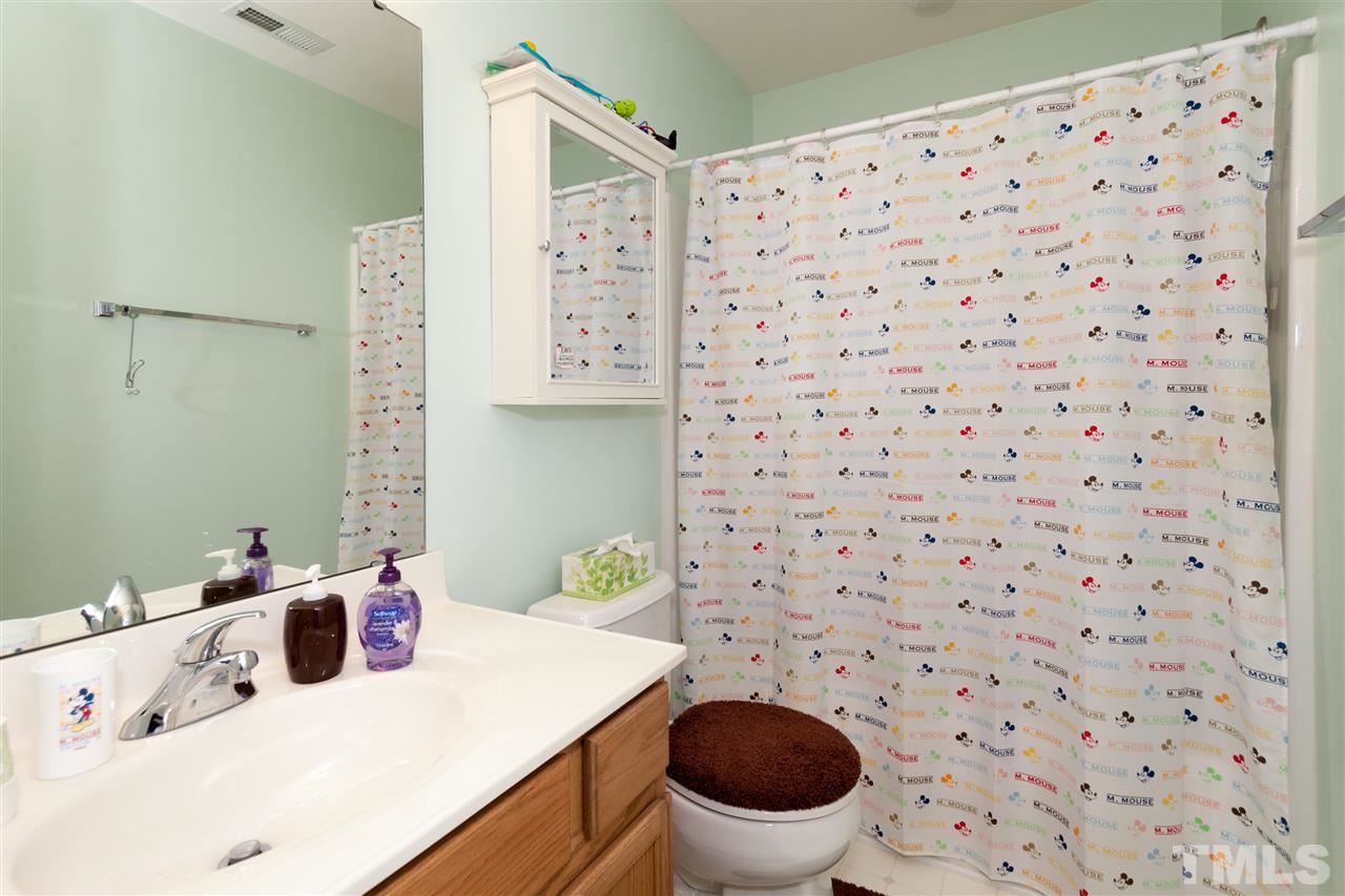 5602 Slide Rock Lane Raleigh, NC 27613 - Photo 13 of 19 a bathroom with a sink toilet and shower