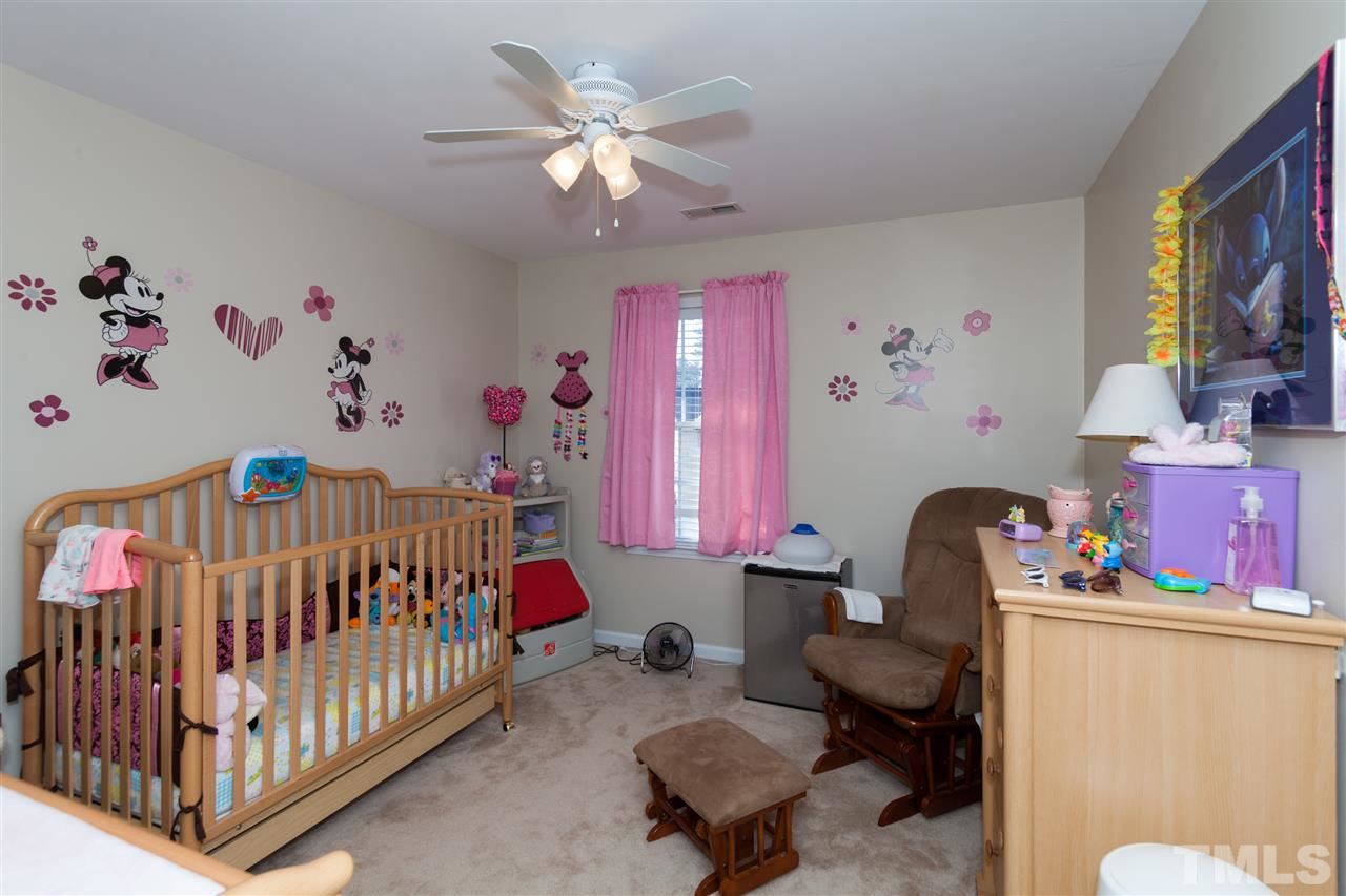 5602 Slide Rock Lane Raleigh, NC 27613 - Photo 14 of 19 a bedroom with furniture and a window
