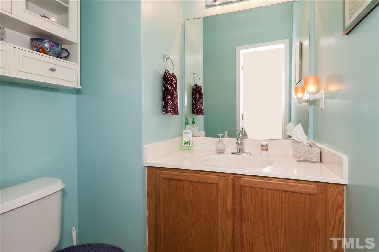 5602 Slide Rock Lane Raleigh, NC 27613 - Photo 16 of 19 a bathroom with a sink and a mirror