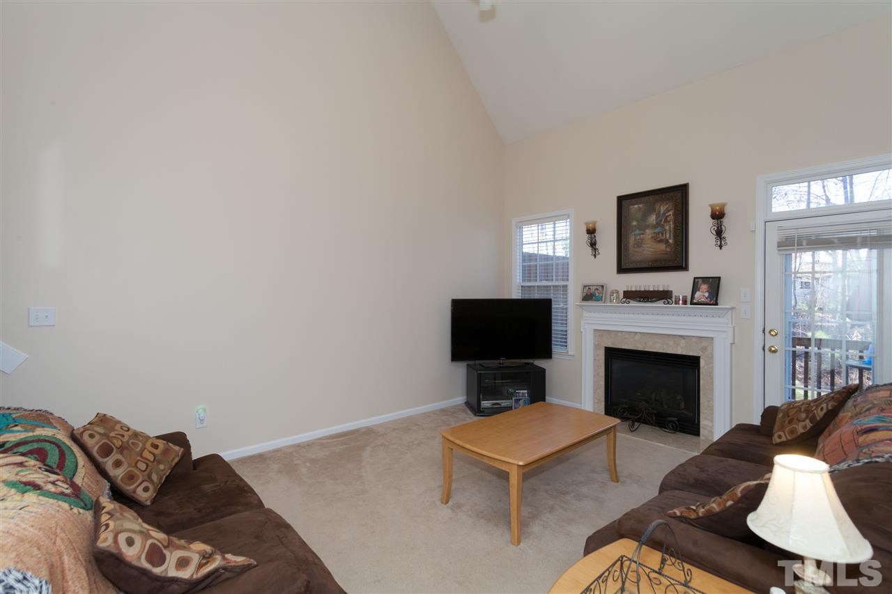 5602 Slide Rock Lane Raleigh, NC 27613 - Photo 17 of 19 a living room with furniture a fireplace and a flat screen tv