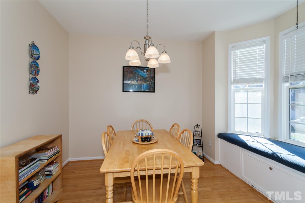5602 Slide Rock Lane Raleigh, NC 27613 - Photo 4 of 19 a spacious bedroom with a bed and a chandelier