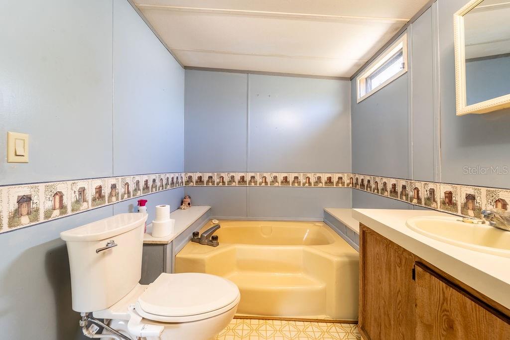 24031 Armadillo Road Astor, FL 32102 - Photo 24 of 43 a bathroom with a sink a toilet and a mirror