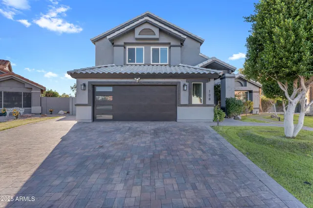 a front view of a house with a yard and garage