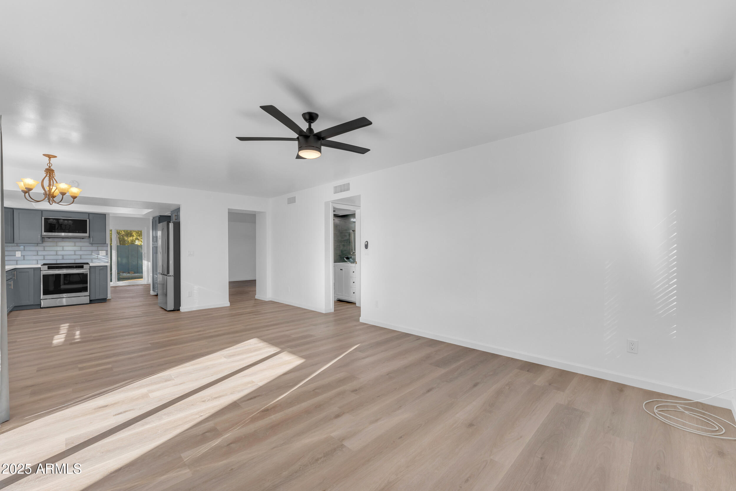 108 South Morning Ridge Drive Gilbert, AZ 85296 - Photo 20 of 49 a view of a livingroom with a fireplace a ceiling fan and wooden floor