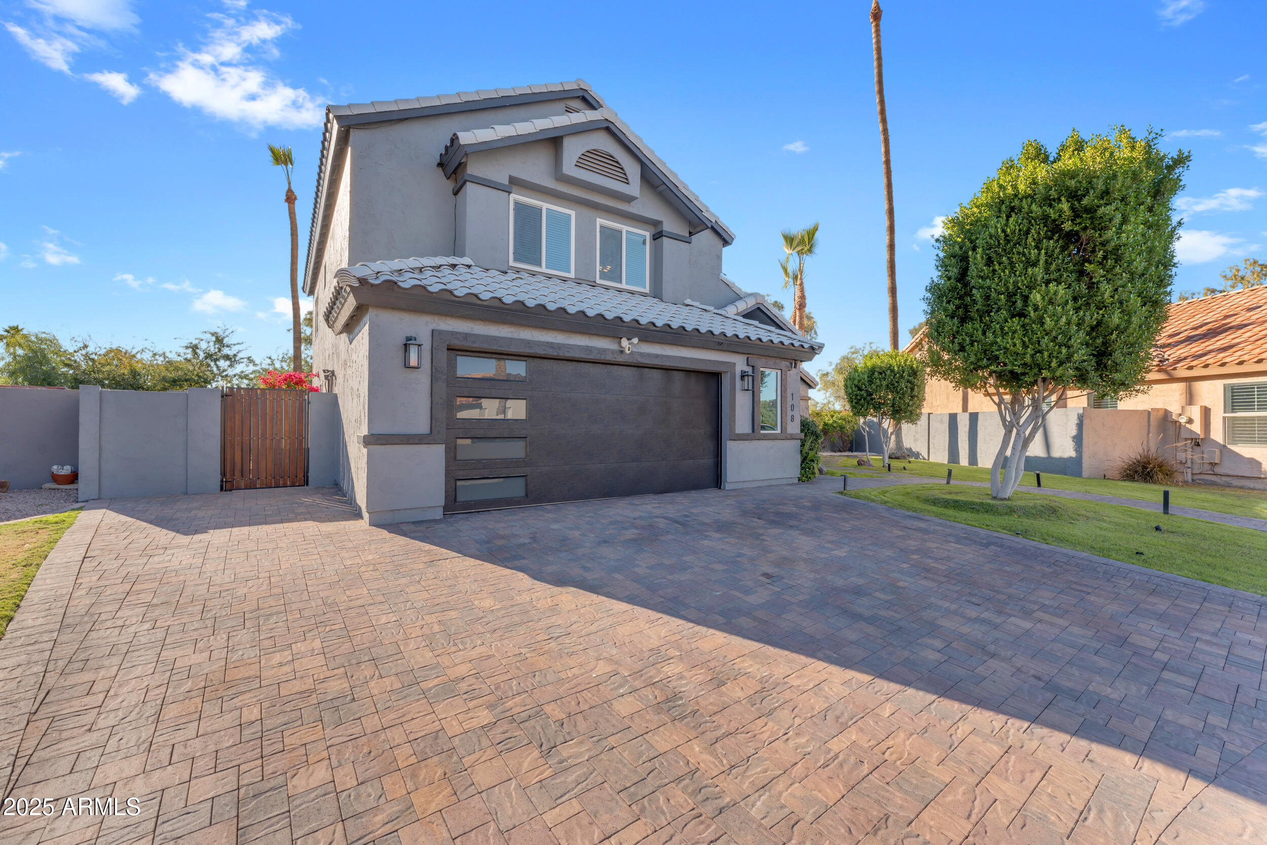 108 South Morning Ridge Drive Gilbert, AZ 85296 - Photo 2 of 49 a front view of a house with a yard and garage