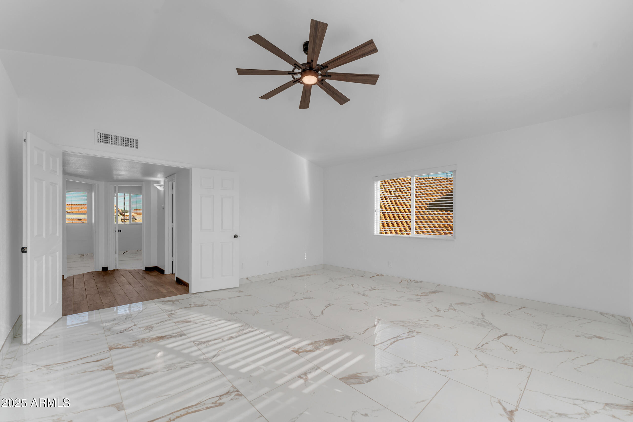 108 South Morning Ridge Drive Gilbert, AZ 85296 - Photo 23 of 49 a view of empty room with wooden floor and ceiling fan