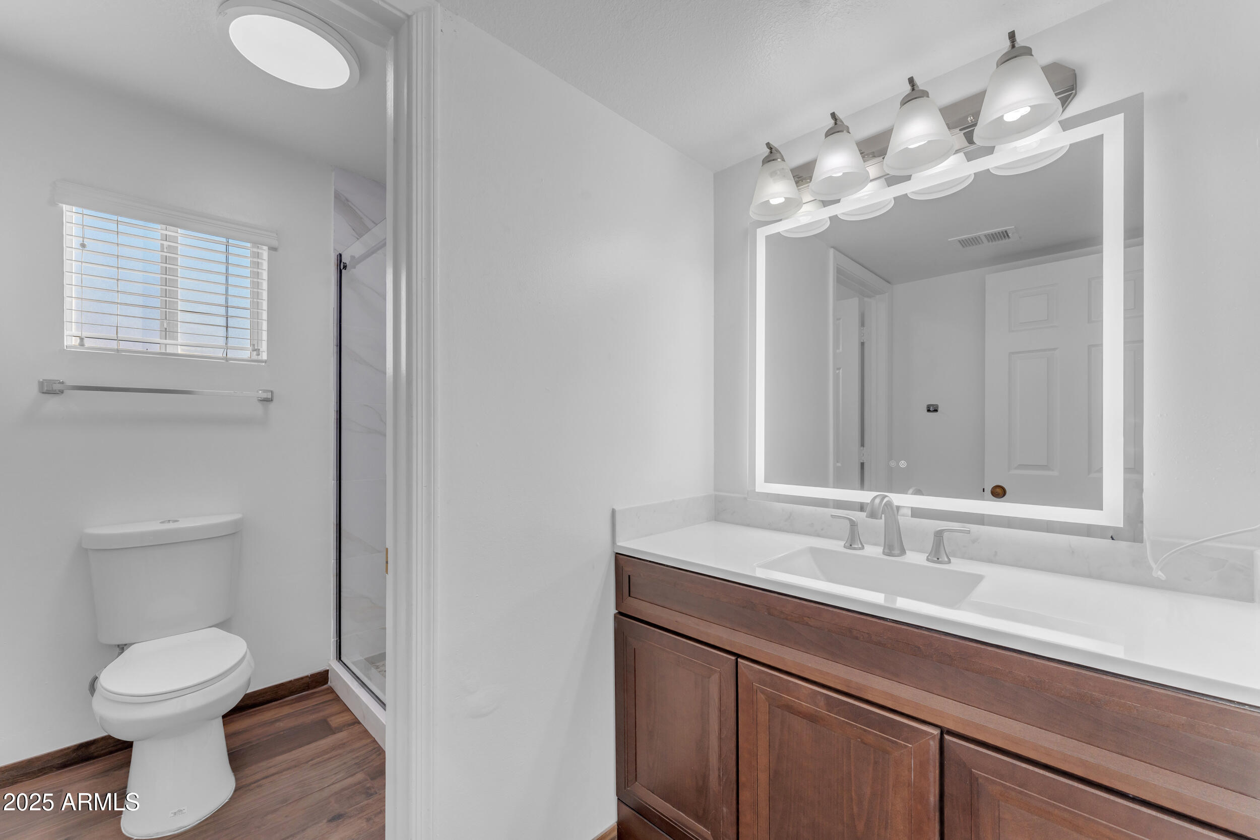 108 South Morning Ridge Drive Gilbert, AZ 85296 - Photo 27 of 49 a bathroom with a toilet a sink and mirror