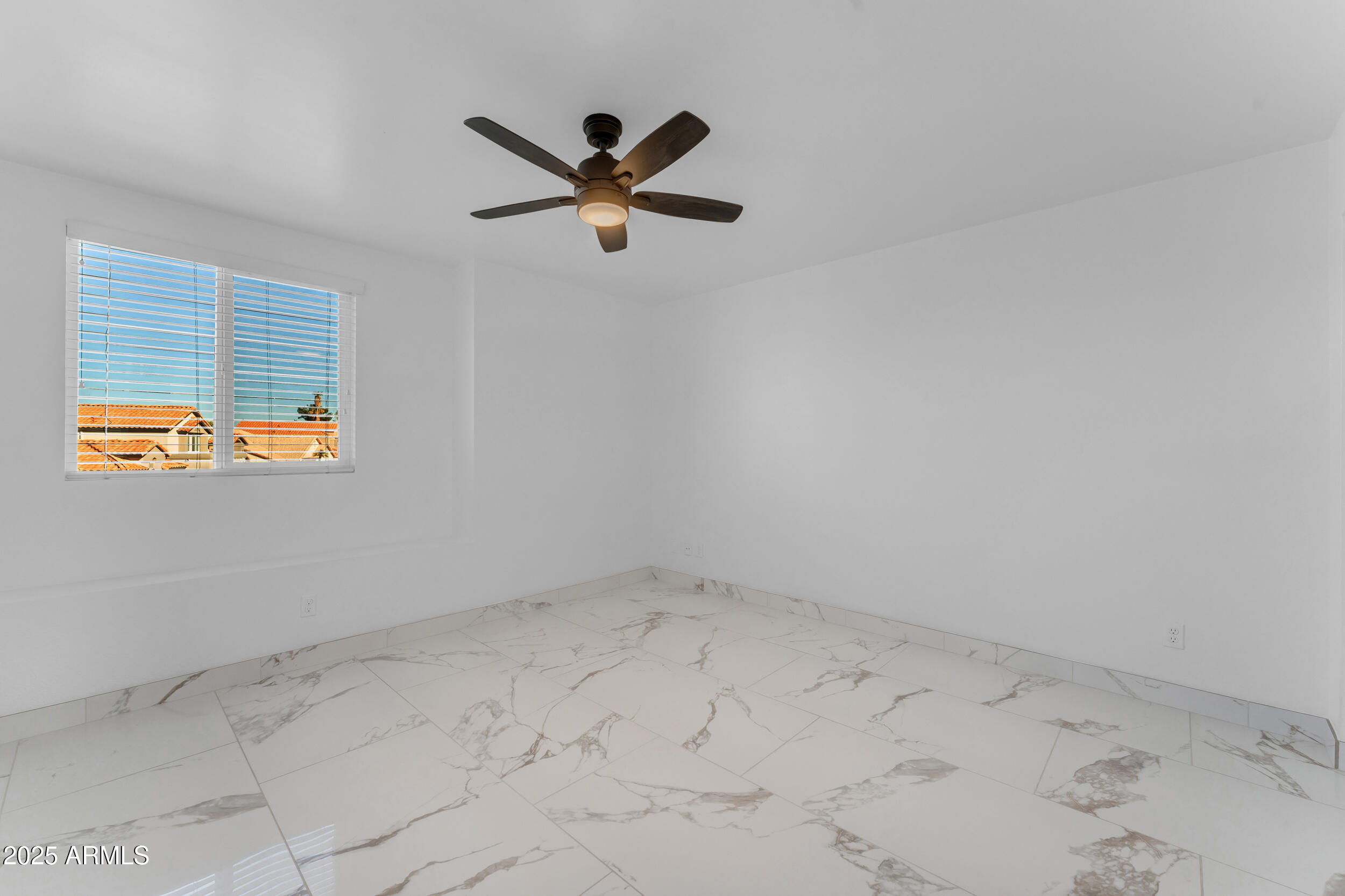 108 South Morning Ridge Drive Gilbert, AZ 85296 - Photo 31 of 49 an empty room with a window and a ceiling fan