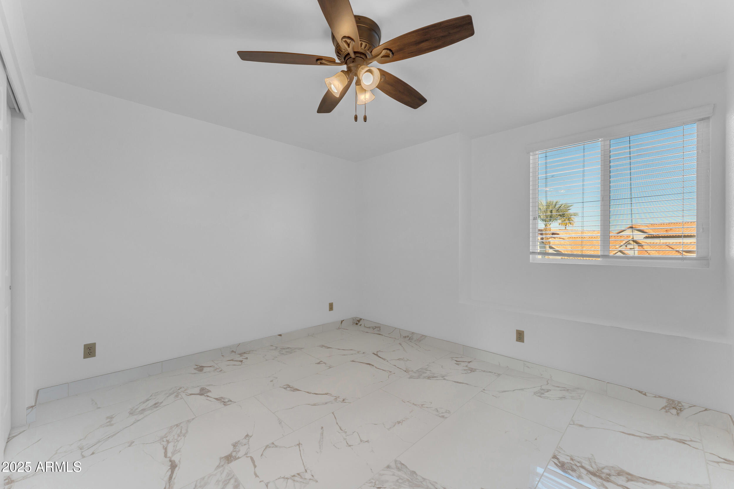 108 South Morning Ridge Drive Gilbert, AZ 85296 - Photo 40 of 49 an empty room with a window and a ceiling fan