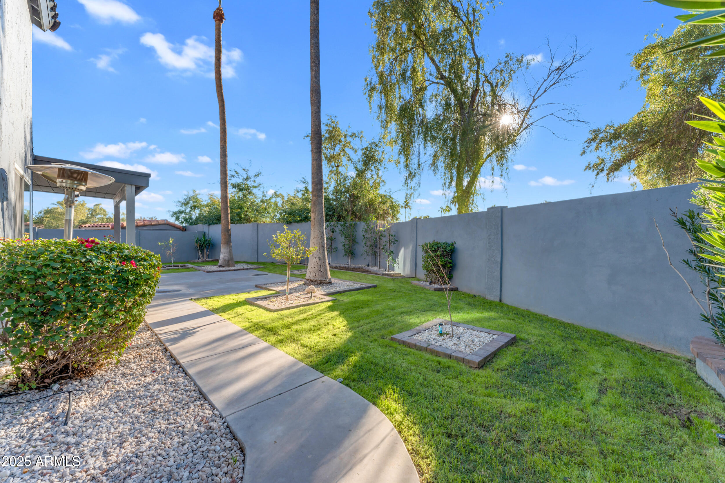 108 South Morning Ridge Drive Gilbert, AZ 85296 - Photo 45 of 49 a view of a backyard with a fountain