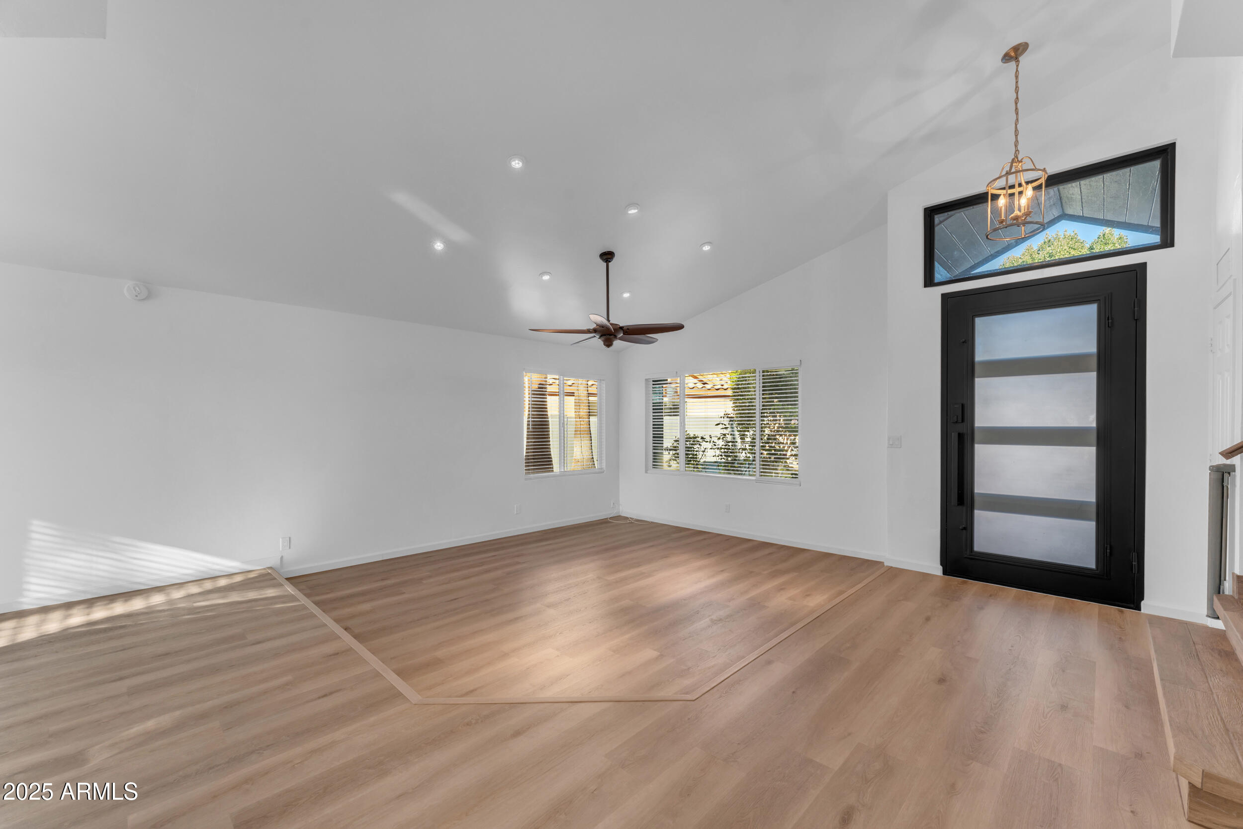 108 South Morning Ridge Drive Gilbert, AZ 85296 - Photo 5 of 49 an empty room with windows and fireplace