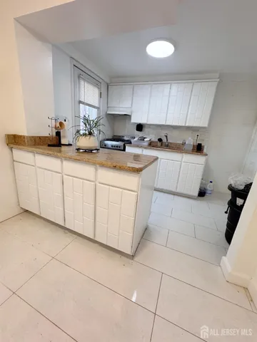 a kitchen with cabinets and appliances