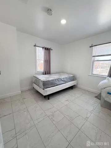 a room with a bed and window