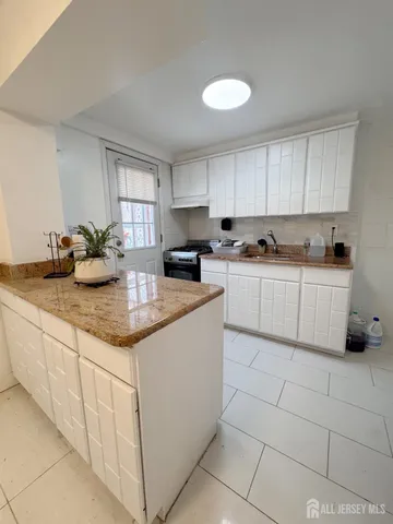 a kitchen with stainless steel appliances granite countertop a sink and cabinets