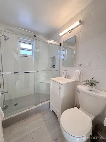 a bathroom with a toilet a sink and shower