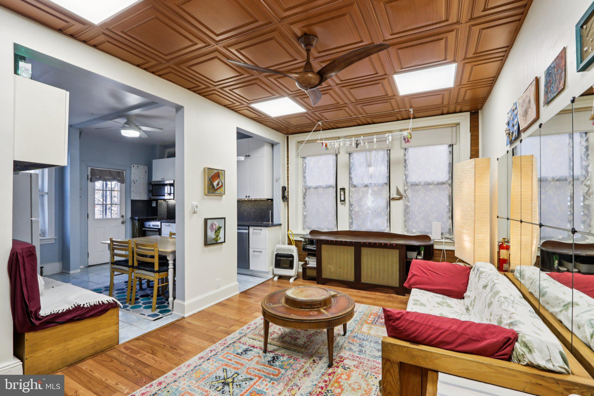 1003 South 46th Street, Unit 4 Philadelphia, PA 19143 - Photo 1 of 32 a living room with furniture and a table